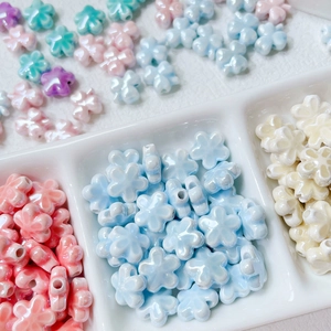 Macro shot of colorful ceramic flower beads with central hole for DIY jewelry making