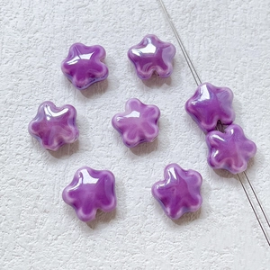 Detailed view of vibrant purple star-shaped ceramic beads for DIY jewelry making
