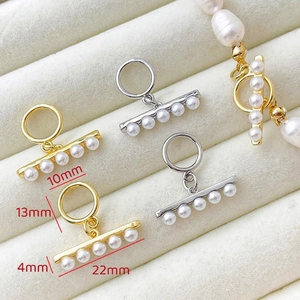 Macro shot of 14k gold plated OT clasp with white pearls for DIY jewelry making