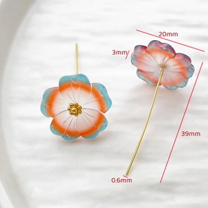 Macro view of handmade floral pins with gradient resin petals and long golden needles