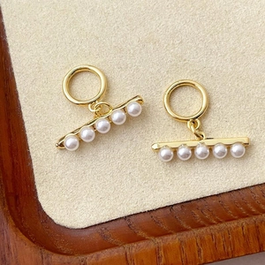 Detail of 14k gold-plated OT toggle clasps with five white pearls for jewelry making
