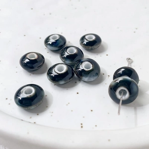 Macro shot of kiln-fired ceramic beads with blue glaze for DIY jewelry making