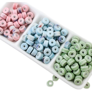 Vintage floral ceramic round beads in pink, blue, and green displayed on a tray