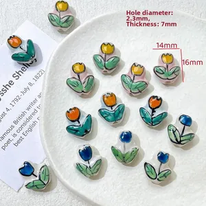 Macro shot of 14x16mm tulip-shaped hand-painted ceramic beads for DIY jewelry making