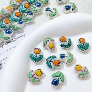 Hand-painted tulip ceramic beads in yellow, blue, and orange for DIY jewelry making