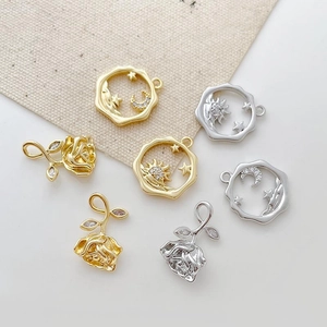 Detail view of 14k gold-plated rose and celestial charms for DIY jewelry making
