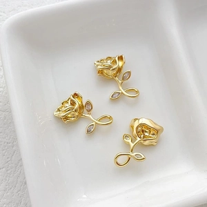 Macro shot of 14k gold-plated rose pendants with white zircons for DIY jewelry making