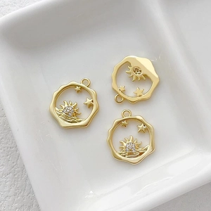 Macro view of 14k gold plated Little Prince charms with zircon sun and star patterns