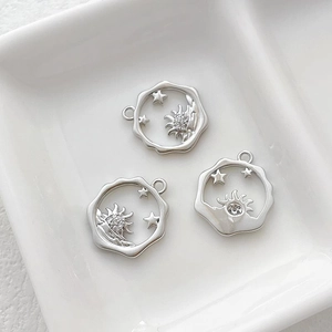 Detailed view of three 14k gold plated Little Prince pendants with sun and star motifs