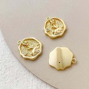 Macro view of 14k gold-plated Little Prince rose pendants with zircon stone and embossed texture
