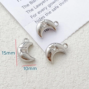 Detailed view of three 15x10mm silver moon pendants with zircon for jewelry making