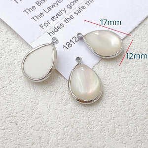 Macro view of teardrop alloy pendants with white shell inlay for DIY jewelry making