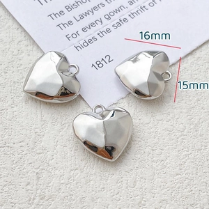 Macro view of 16mm heart alloy pendant with mirror finish for DIY jewelry making