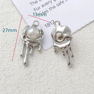 Macro view of silver melting rose pendants with pearl inlay for jewelry making