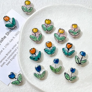 Hand-painted tulip ceramic beads in yellow, orange, and blue for DIY jewelry making