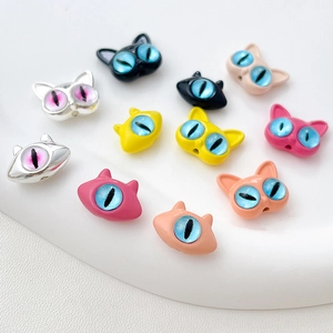 Close-up of colorful cartoon cat head charms for DIY jewelry making and beading