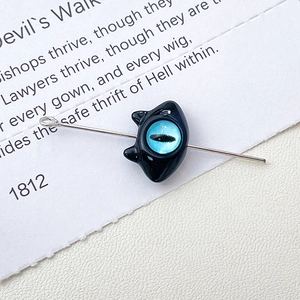 Detailed close-up of a black cat bead featuring a blue devil eye for jewelry making