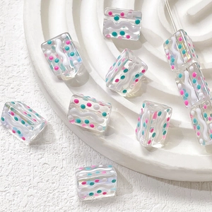 Macro detail of hand-painted dopamine style colorful polka dot and stripe glass beads