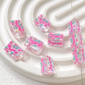 Detailed view of handmade colorful polka dot and stripe glass beads for DIY jewelry making
