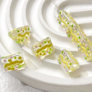 Macro detail of hand-painted colorful striped glass beads for DIY jewelry making