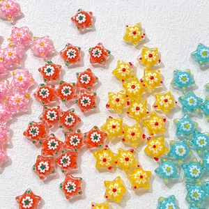 Macro shot of colorful glass star beads with flower patterns for DIY jewelry making
