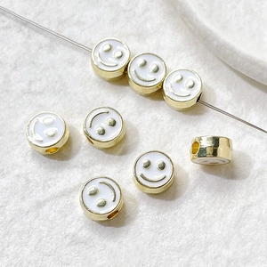 Macro view of colorful enamel smiley face beads for DIY jewelry making and handmade crafts