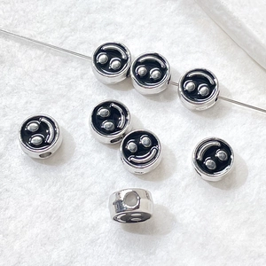 Close-up of DIY smile face beads on metal wire for handmade jewelry making