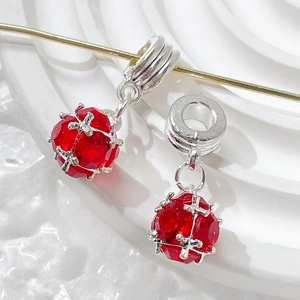 Macro shot of ruby red faceted crystal charm with silver threaded bail for DIY jewelry
