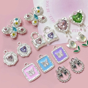 Assorted alloy jewelry charms featuring crystal tulips and heart pendants for DIY crafts