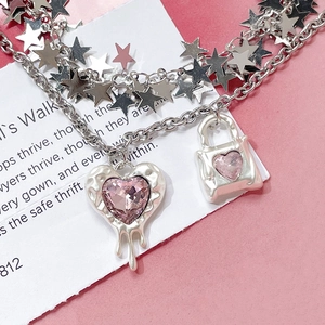 Pink heart pendant necklace with silver stars and Y2K aesthetic melting design