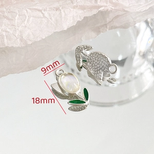 Macro detail of tulip pendant charm with white gemstone and green enamel leaves for DIY