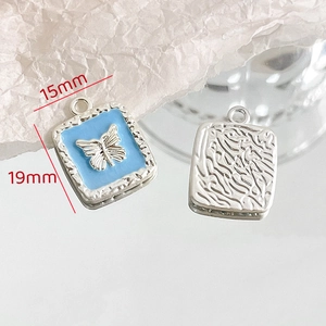 Detailed macro of 15x19mm light blue enamel heart pendant with silver butterfly relief