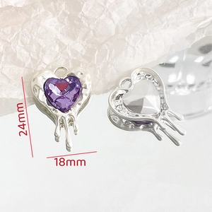 Macro detail of 24x18mm silver heart pendant with purple gemstone and fluid metal design