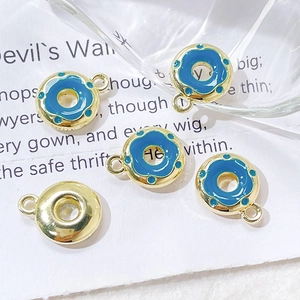 Macro detail of colorful doughnut alloy charms for DIY jewelry making with blue enamel finish