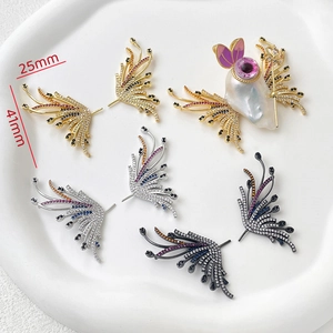 Macro shot of 41x25mm gold-plated wing charms with colored zircons and baroque pearls