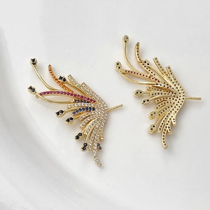 Detail of gold-plated wing charms with colorful cubic zirconia and pin back structure