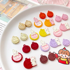 Detail of bunny and mooncake charms with festive Chinese character relief carvings