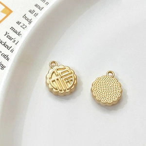 Detailed view of mooncake shaped gold alloy Fu pendant charm for DIY jewelry making