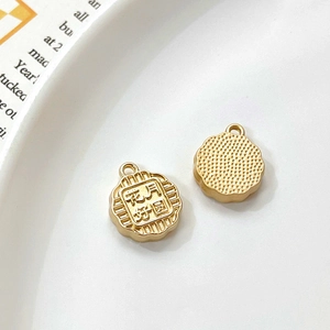 Close-up of golden charms with Mid-Autumn festive text and textured back on tray