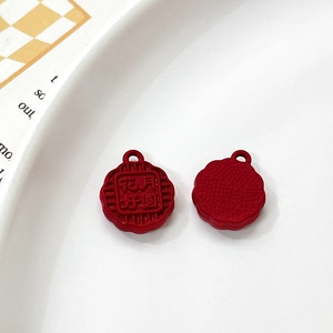 Detail of red mooncake charms with embossed Chinese characters for DIY jewelry making
