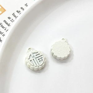 Macro shot of white rabbit mooncake charms featuring Fu character for DIY jewelry