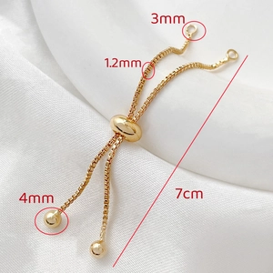 Detail of 14k gold-filled adjustable box chain with sizing slider on white silk