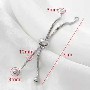 Detailed silver adjustable box chain extender with silicone slider bead on silk background