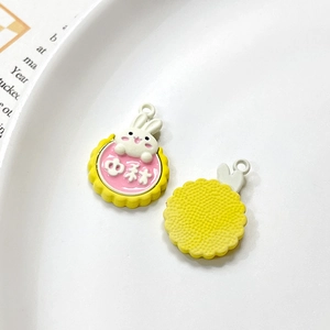 Macro view of Mid-Autumn bunny mooncake charms with detailed enamel finish and honeycombed back