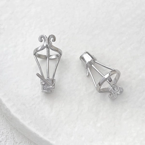 Detail view of hollow silver plated baroque style metal pendants for DIY jewelry making