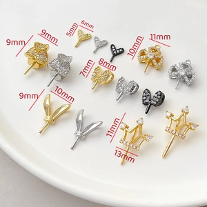 Detailed macro view of assorted zircon-encrusted gold-plated jewelry pin pendants