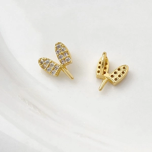 Close-up of gold-plated rabbit ear charms with micro-pave zircons for DIY jewelry