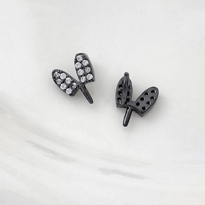 Macro view of black plated heart-shaped jewelry components with micro-set zircon stones