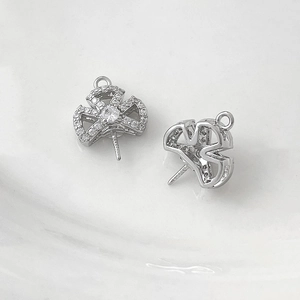 Macro view of micro-pasted zircon clover pins for baroque pearl jewelry making