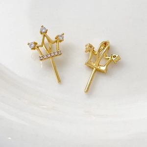 Macro shot of gold-plated crown pendant with white cubic zirconia for DIY jewelry